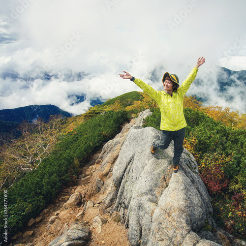 Epic adventure of hiker do trekking activity in mountain of Northern Japan Alps, Nagano, Japan, with panoramic nature mountain range landscape. Motivation leisure sport and discovery travel concept. photo