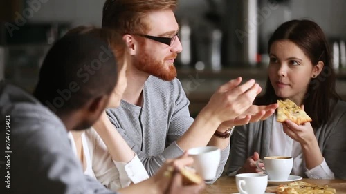 Wallpaper Mural Diverse friends talking sharing pizza discussing interesting news during hangout Torontodigital.ca