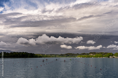 paddling before the storm in a lake in catalonia