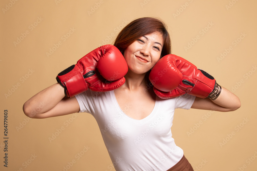 Young Asian woman with red boxing gloves. Young Asian woman with red boxing gloves.