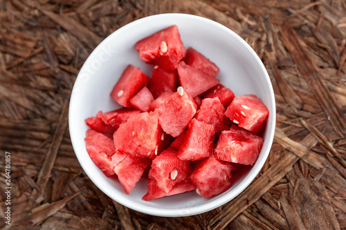 Foto Organic watermelon in a white bowl ready to eat on wooden background