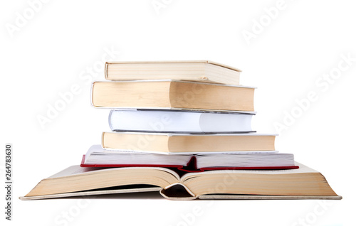 Stack of open and closed hardback books isolated on white background.