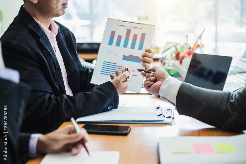 Group of business people who explain about graphing, finance and investment in the meeting. Group of business people who explain about graphing, finance and investment in the meeting.