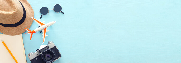 Top view banner photo of traveling concept with accessories over blue background