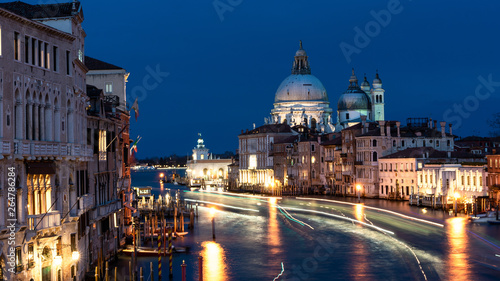 Beautiful view on Basilica di Santa Maria della Salute in golden evening light at sunset in Venice, Italy