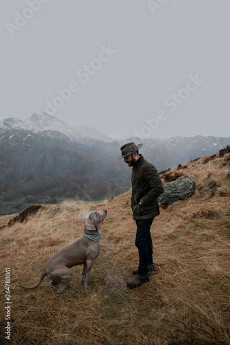 man with dog in the mountains