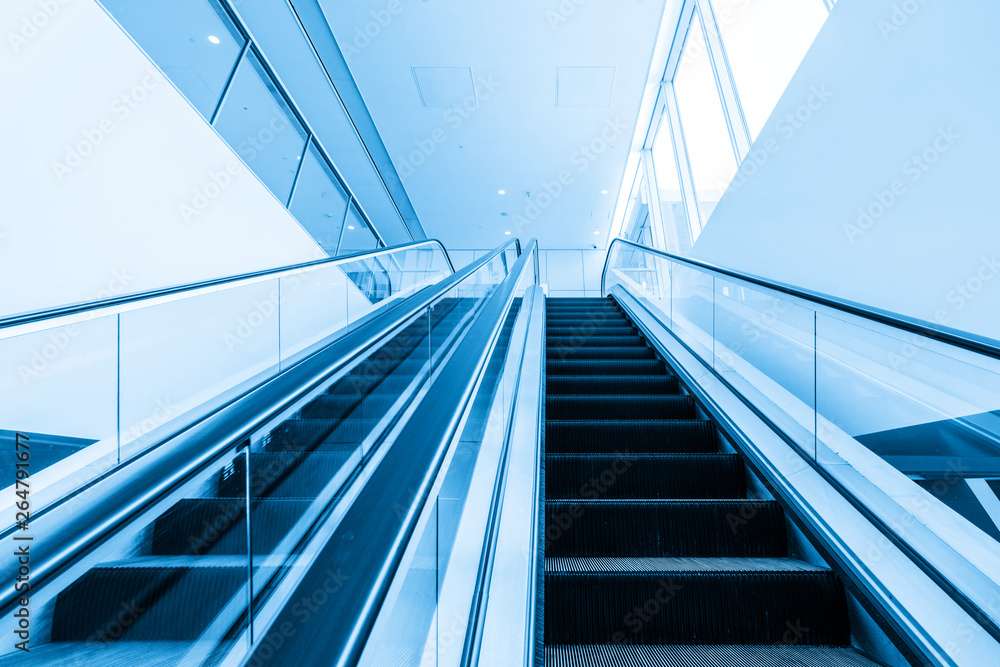 The escalator is in the mall The escalator is in the mall