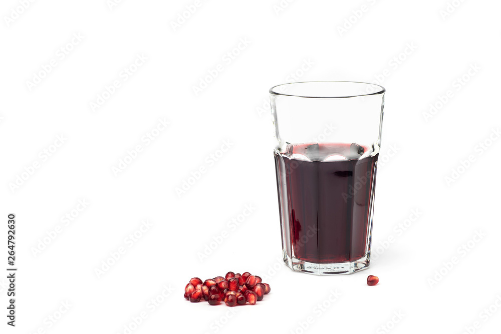 Pomegranate juice in a glass with pomegranate fruit on a white background Pomegranate juice in a glass with pomegranate fruit on a white background