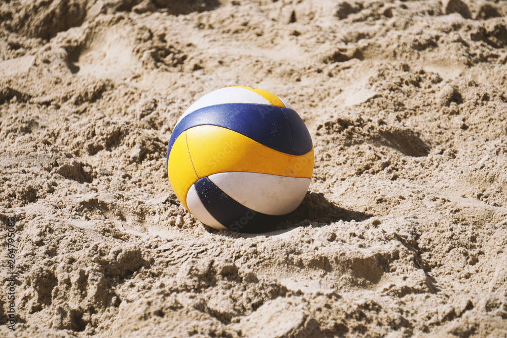 beach volleyball ball lying in the sand - summer trend sport