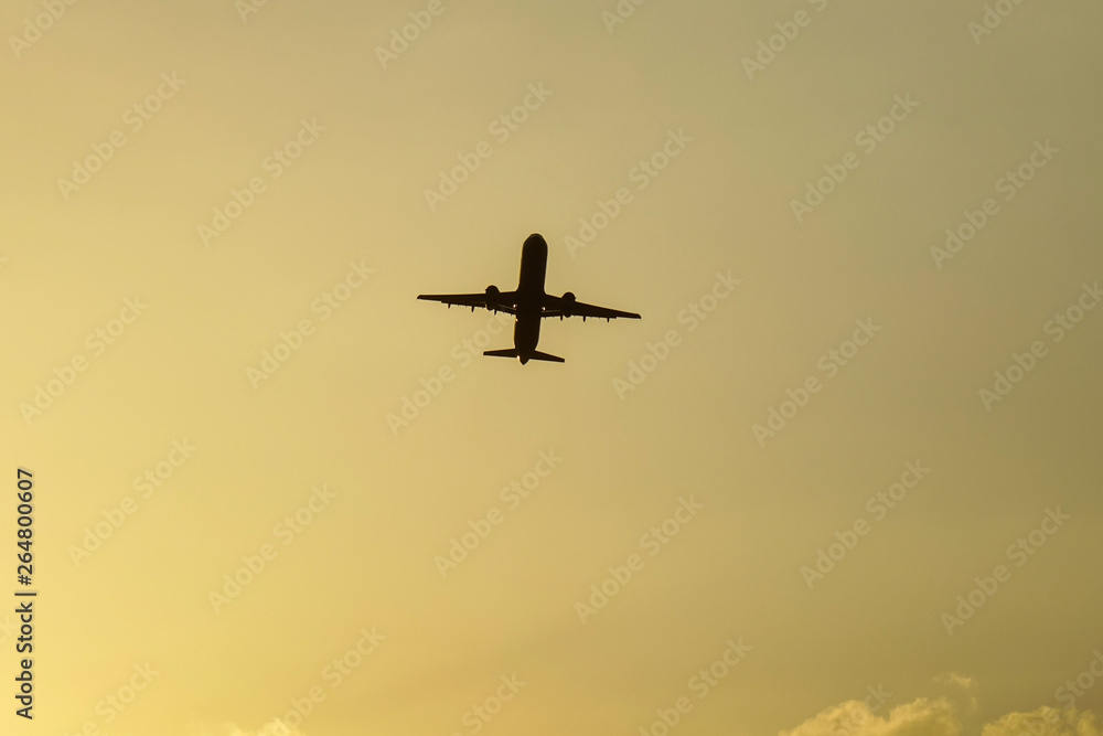 Passenger airplane taking-off in sunset Passenger airplane taking-off in sunset