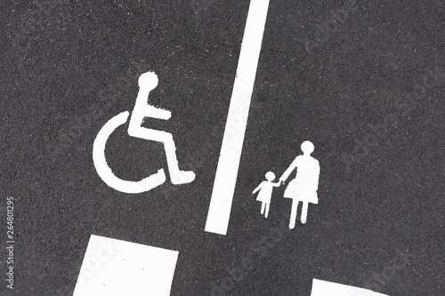Parking signs: disabled sign and family parking sign.