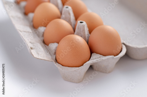 chicken brown eggs in a tray, close