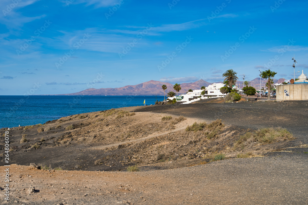 LANZAROTE, CANARY ISLANDS, SPAIN - APRIL 15, 2019: Province of Las Palmas. View of the Atlantic coast, hotels and volcanic hills