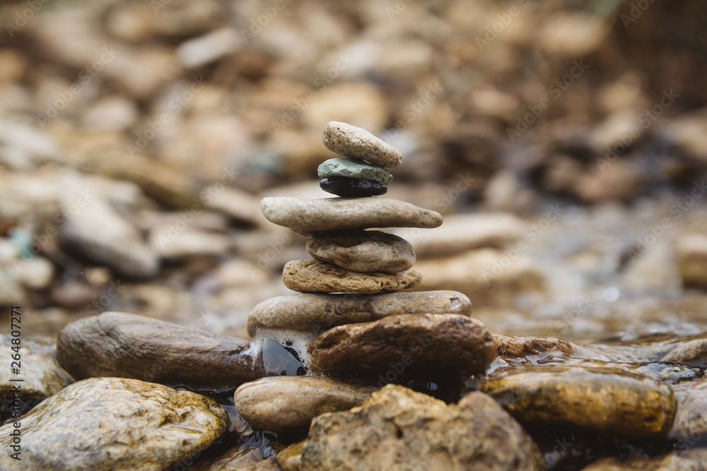 Stones pyramid on pebble beach symbolizing stability, zen, harmony, balance. Shallow depth of field Stones pyramid on pebble beach symbolizing stability, zen, harmony, balance. Shallow depth of field