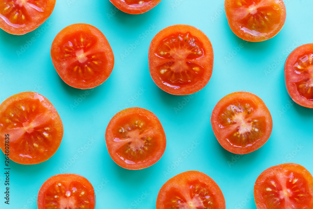 halves of tomatoes pattern on bright turquoise background halves of tomatoes pattern on bright turquoise background