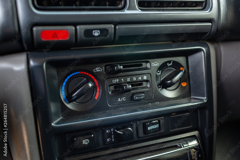 Old Japanese made sports car interior center dashboard with climate control knobs. Old Japanese made sports car interior center dashboard with climate control knobs.
