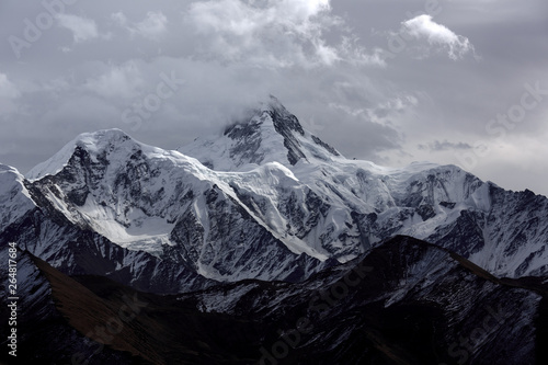 Minya Konka (Mount Gongga, Epic Tibetan Snow Mountain) - Gongga Shan in Sichuan Province, China. View from the west at Yaha Pass, summit shrouded in clouds. Highest Mountain in Sichuan Province China.