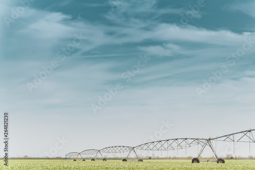 Large irrigation systems water fields with young plants
