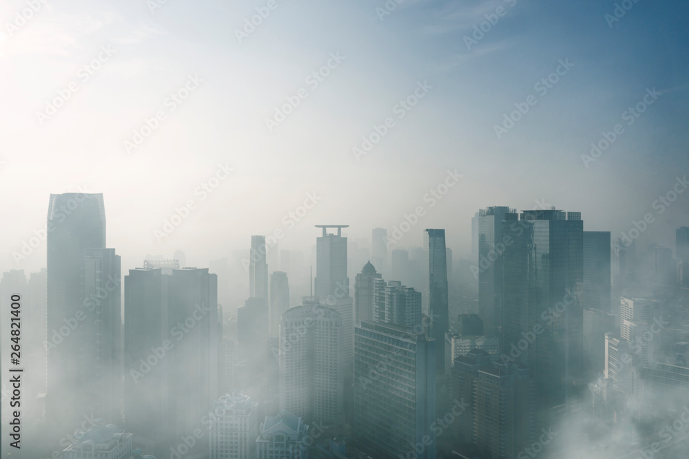 Misty skyscrapers in Jakarta downtown at morning