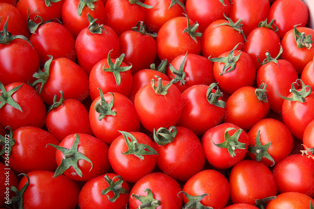 Background of many of juicy ripe red tomatoes Background of many of juicy ripe red tomatoes