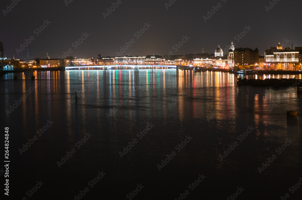 Night panoramic view of illuminated Neva River and Tuchkov Bridge, Saint Petersburg, Russia
