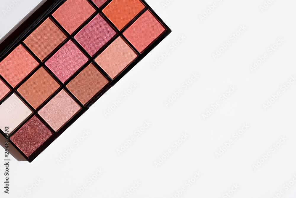 Top view of make up cosmetic - eye shadow palette in pink and red colors. Copy space on white background. Top view of make up cosmetic - eye shadow palette in pink and red colors. Copy space on white background.