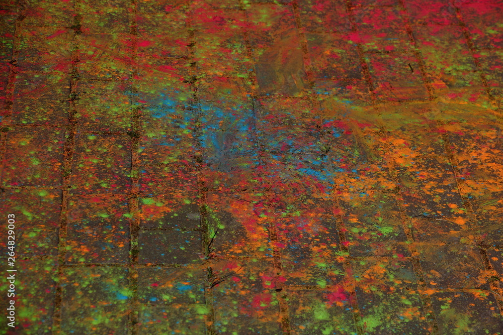 Multi-colored paints on the pavement - texture for background