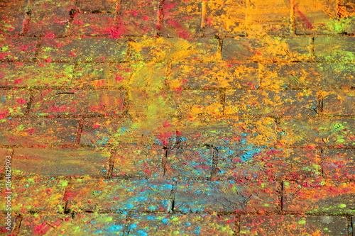 Multi-colored paints on the pavement on oaint Holi Festival - texture for background photo