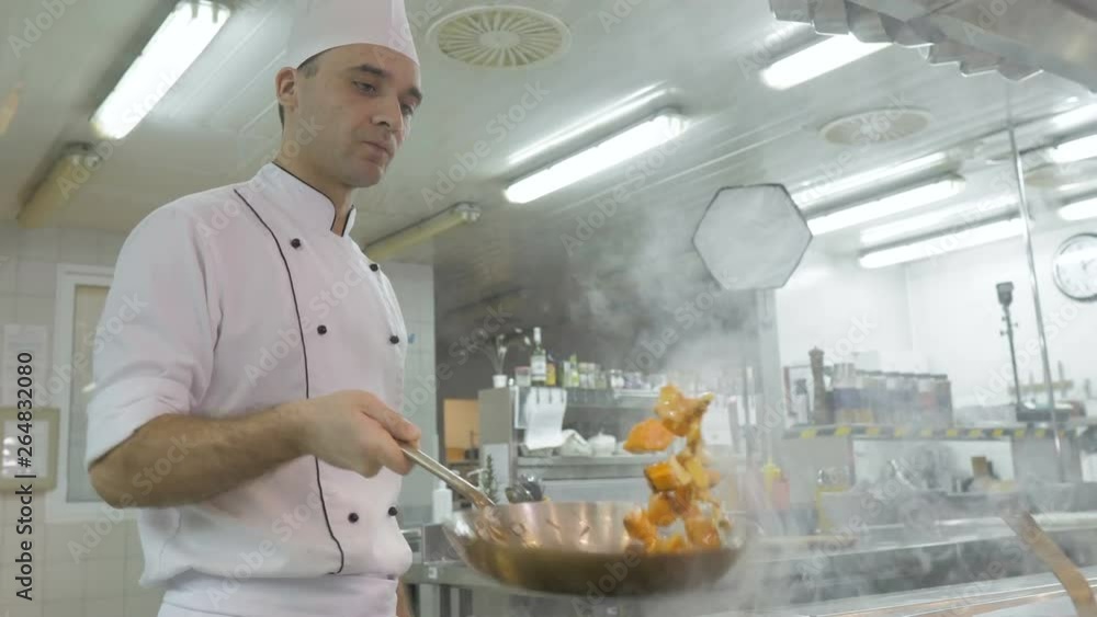 Chef cooking vegetables in pan in the kitchen of the restaurant or hotel Chef cooking vegetables in pan in the kitchen of the restaurant or hotel