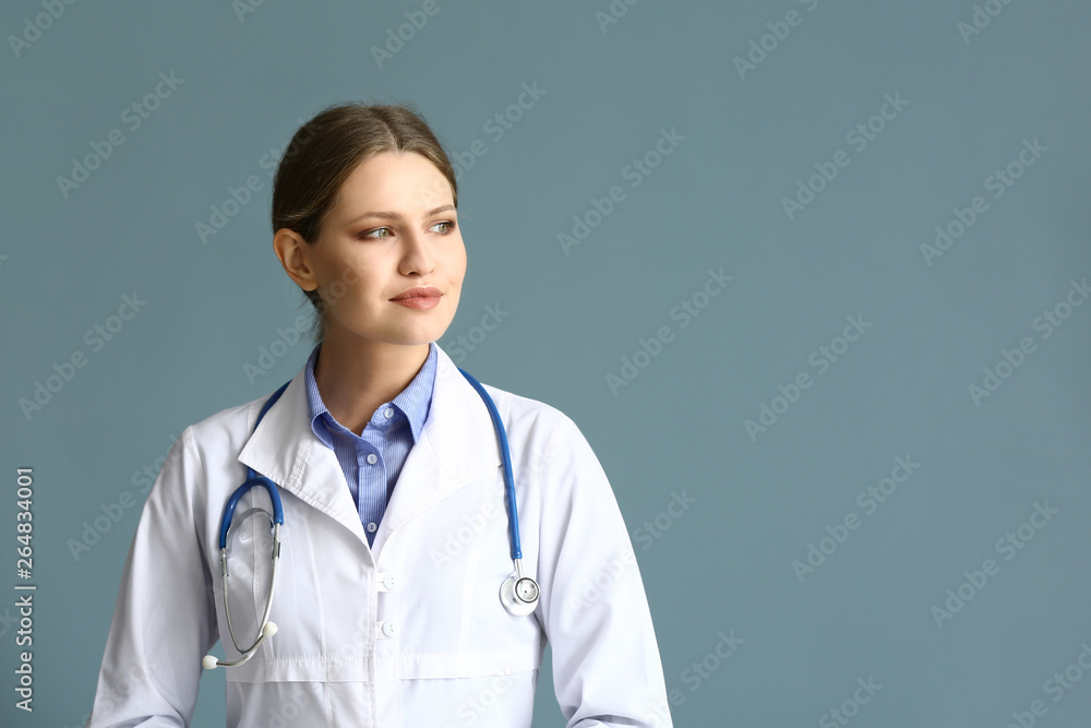 Portrait of young gynecologist on grey background Portrait of young gynecologist on grey background