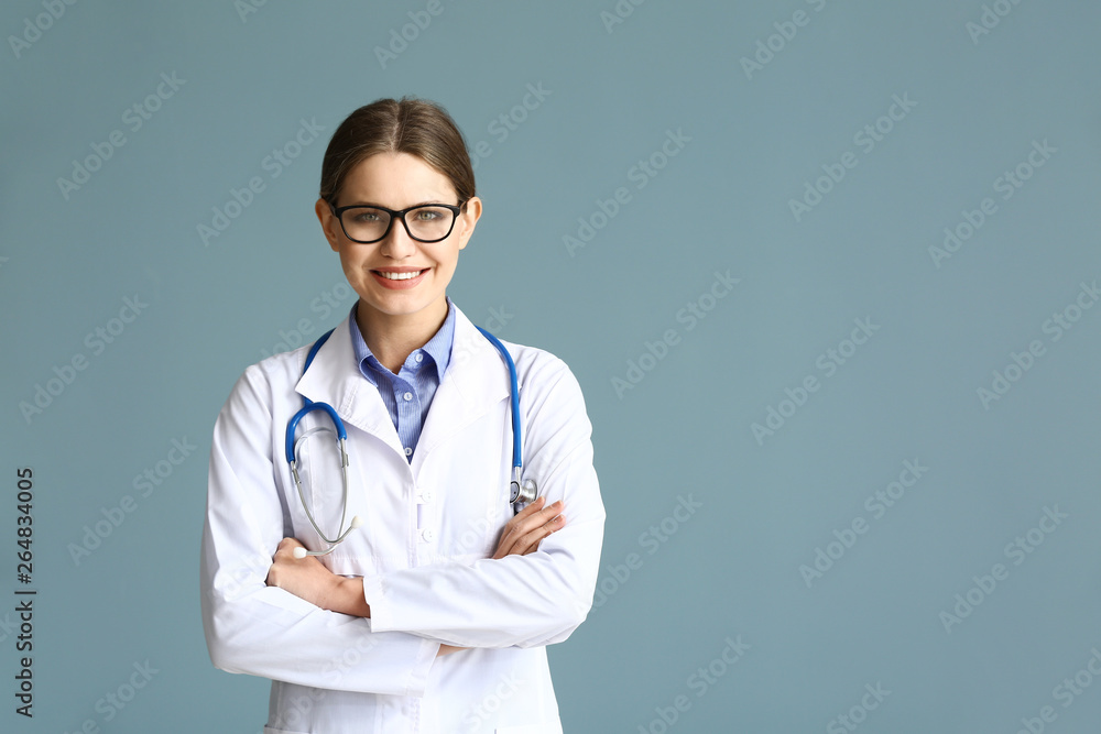 Portrait of young gynecologist on grey background Portrait of young gynecologist on grey background