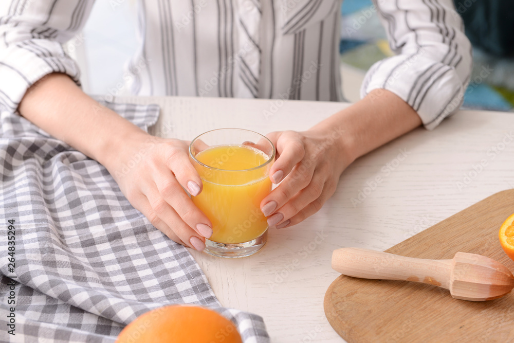 Young woman with glass of fresh juice at home, closeup Young woman with glass of fresh juice at home, closeup