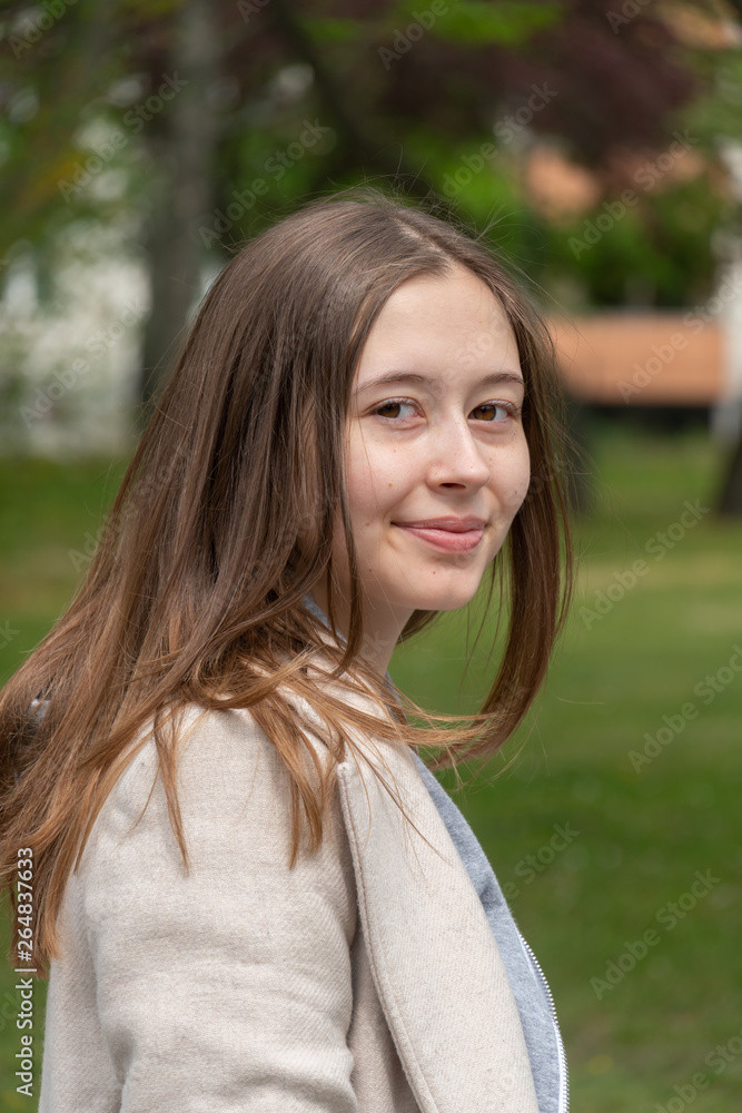 Beautiful young woman posing smiling and looking at the camera Beautiful young woman posing smiling and looking at the camera
