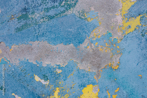 Vintage wall texture. Grunge background with blue yellow speckled paint on concrete