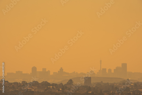 The Johannesburg skyline silhouetted against a golden sky