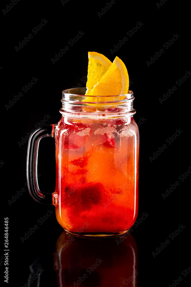 Cold fruit lemonade in mason jar isolated on black Cold fruit lemonade in mason jar isolated on black