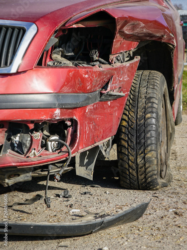 A closeup of a broken car after a car crash accident on the road