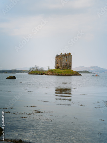  Beautiful view of the castle in Scotland during a cloudy day. Taken near Castle Stalker: is a four-storey tower house or keep picturesquely set on a tidal islet on Loch Laich, in Loch Linnhe. photo