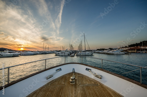 Wide angle shot of front of the yacht in marina in sunset