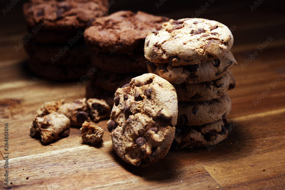 Fototapeta premium Chocolate cookies on wooden table. Chocolate chip cookies