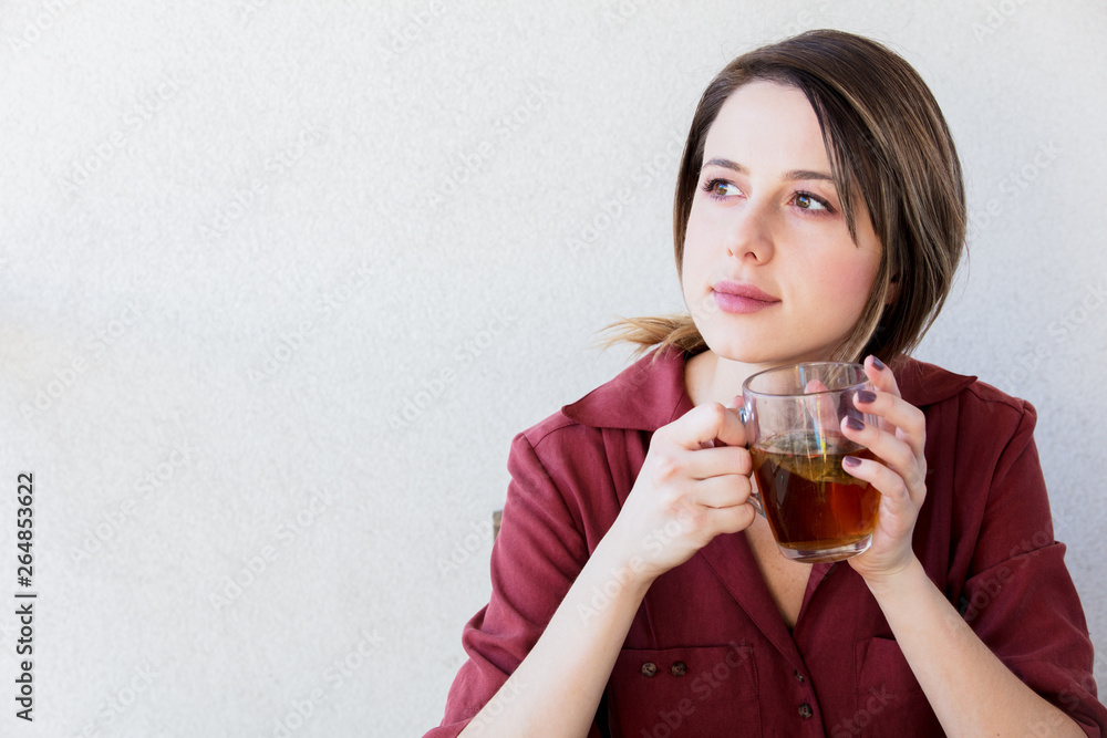 Beautiful woman with tea cup at home in a morning Beautiful woman with tea cup at home in a morning
