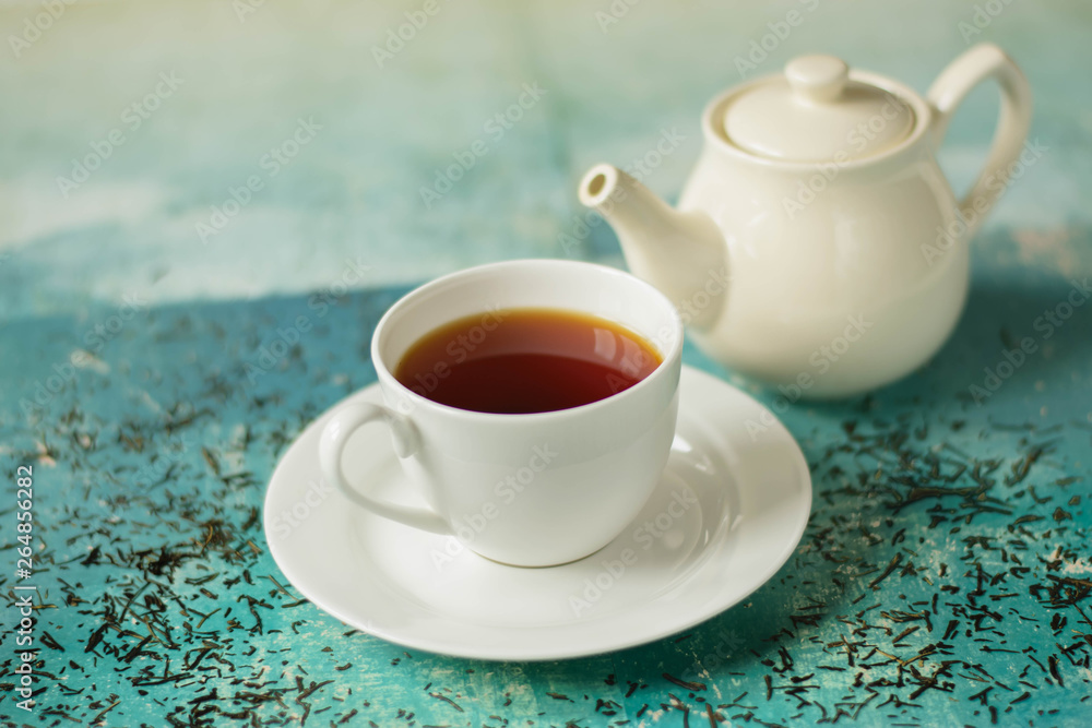 A cup of hot tea with different colours background.