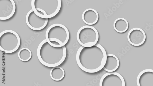 Abstract illustration of randomly arranged white rings with soft shadows on gray background