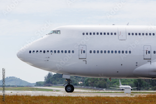 Modern passenger double-decker airplane is taxiing to take off. Wide-body aircraft on runway, close up, side view. Vacation, aviation, travel concept