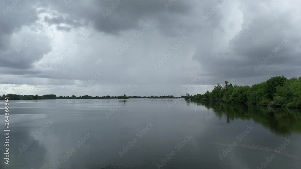 A beautiful landscape of a river in Portugal, under the dark sky