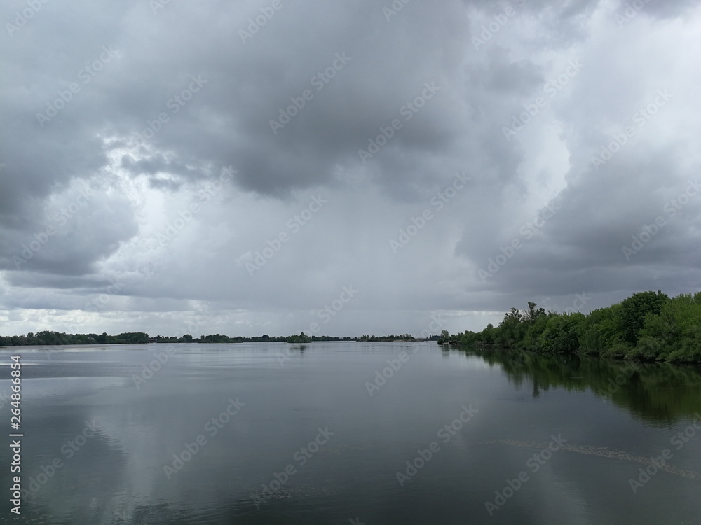 A beautiful landscape of a river in Portugal, under the dark sky A beautiful landscape of a river in Portugal, under the dark sky