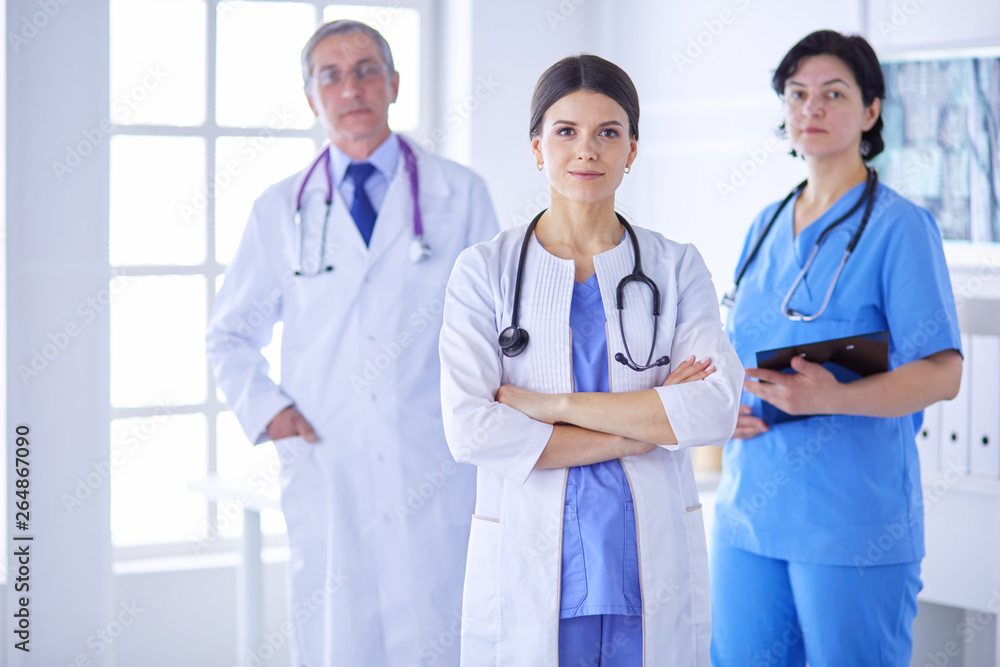 Group of doctors and nurses standing in the hospital room Group of doctors and nurses standing in the hospital room
