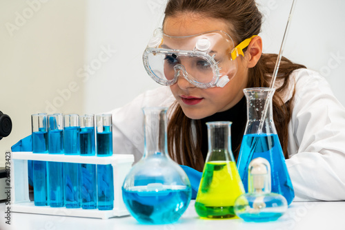 Картината върху платно Young woman scientist working in chemical laboratory and examining biochemistry lab sample
