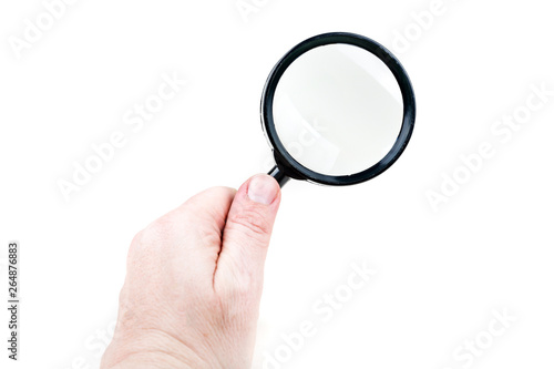 Hand holding a black magnifying glass over a white background