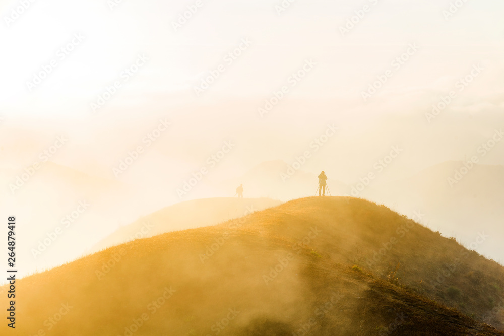 The mountain wind turbines in the sunrise and sunset in the sea of clouds